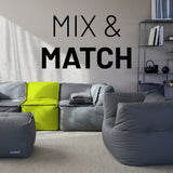 LUMALAND Sitzsack-Sofa Mittelstück Apfelgrün kombiniert mit grauen Modulen im modularen System, Mix-&-Fix-Reißverschluss sichtbar.